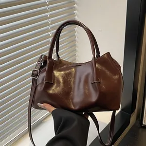 Retro dark brown pleated leather handbag with glossy finish and adjustable shoulder strap