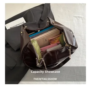 Detail view of large dark brown tote bag interior capacity with everyday essentials