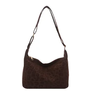 Leopard print faux suede shoulder bag with adjustable strap and zipper closure