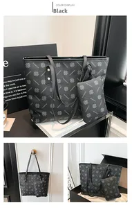 Vue détaillée du set cabas noir à motif trèfle avec sa pochette zippée assortie