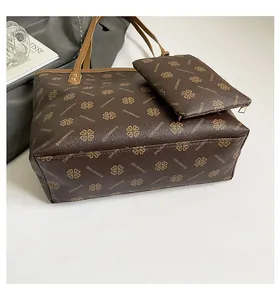 Detailed macro view of brown patterned tote bag featuring leather texture and DIANMOND print