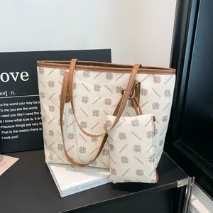 Off-white printed tote bag set with brown handles and purple clover pattern motifs