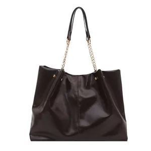 Glossy dark brown tote bag with chain strap and spacious interior in a frontal view