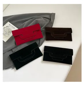 Close-up of minimalist rectangular envelope clutches with a unique tiered flap design