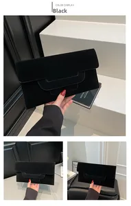 Detail view of the black envelope clutch bag featuring a unique layered U-shaped flap design