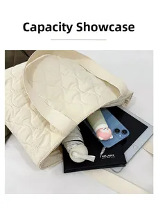 Capacity display of the cream quilted tote bag showing space for a tablet and daily items