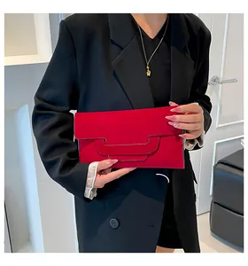 Modern red envelope clutch bag with unique geometric cut and matte texture finish