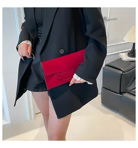 Close-up of elegant red suede envelope clutch bag with multi-layer wavy scalloped edges