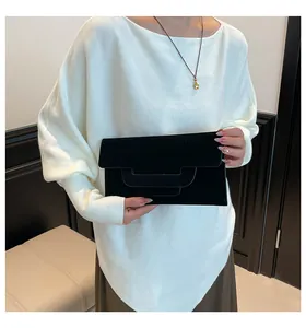Detail of the black suede envelope clutch bag showing its tiered geometric fold design