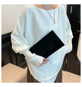 Detail of elegant black leather envelope clutch bag with unique H-shaped strap closure design