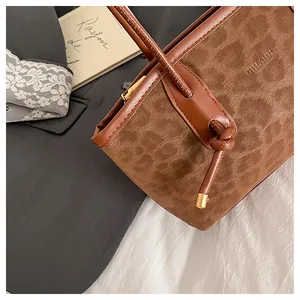 Detail view of brown leopard print tote bag with GTHALDI logo and drawstring finish