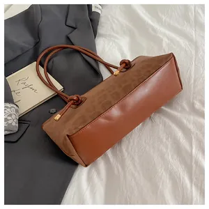 Detail of caramel brown tote bag with leopard print panel and knotted handles