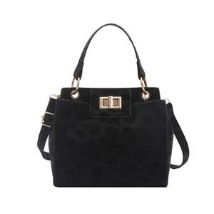 Chic black leopard print crossbody bag with golden twist lock on white background