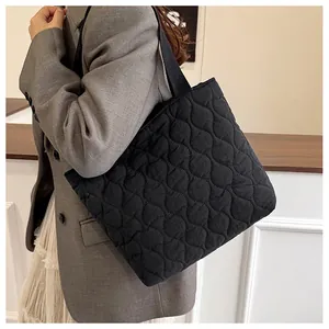 Close-up of black quilted spacer cotton tote bag showing detailed diamond stitching pattern