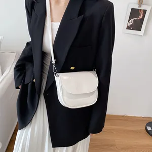Minimalist white saddle bag in polished leather with adjustable strap for women