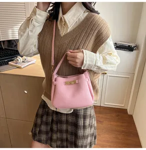 Litchi pattern leather bucket bag with gold clasp shown in a lifestyle setting