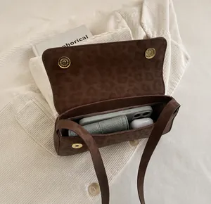 Top view of leopard print shoulder bag interior showing storage for phone and accessories