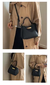 Close-up of black litchi pattern leather bucket bag with elegant gold twist-lock detail
