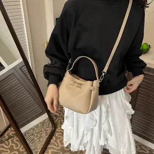 Chic beige bucket bag with litchi grain faux leather and metallic clasp for women