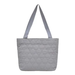Light grey quilted puffer tote bag with wave diamond pattern and woven handles