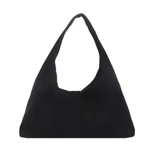 Large black faux suede hobo shoulder bag with minimalist stitching on a white background