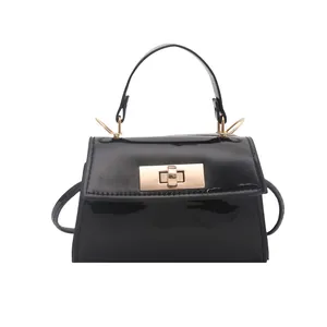 Elegant black patent leather mini handbag with gold metal clasp and crossbody strap