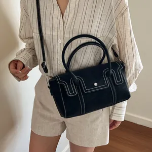 Structured black leather handbag with white contrast stitching and a dual top handle design