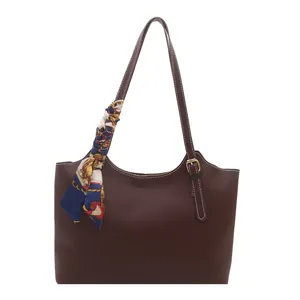 Retro dark brown tote bag with white contrast stitching and patterned silk scarf accent