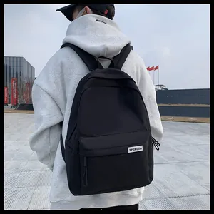 Dettaglio dello zaino in nylon nero con grande tasca frontale ed etichetta del marchio XPENGDA