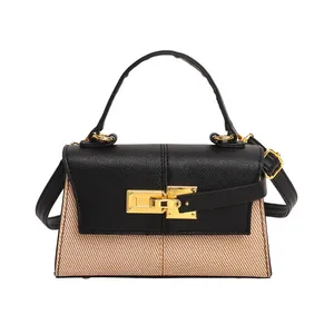 Sac trapèze avec surpiqûres contrastées, texture tissée et serrure dorée