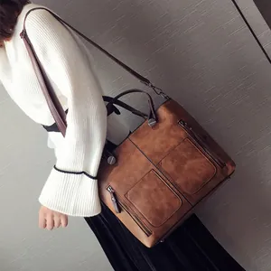 Retro brown PU leather tote bag with double front pockets and adjustable shoulder strap