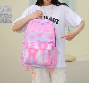 Pink and blue tie-dye school backpack shown on a model for daily outdoor use