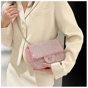 Detailed close-up of a pink rhinestone square crossbody bag with silver chain strap