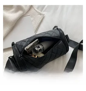 Top view of black quilted cylinder bag interior showing ample capacity for daily items