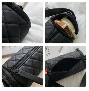 Detail view of black quilted cylinder bag showing large capacity and zipper texture