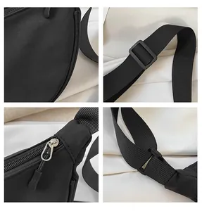 Detail view of water-resistant nylon material, metal zipper, and adjustable strap system