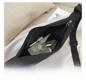 Detail view of black nylon dumpling bag showing large interior capacity for cosmetics