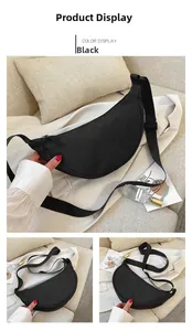Detail view of black crescent dumpling bag with adjustable nylon strap and metal zipper