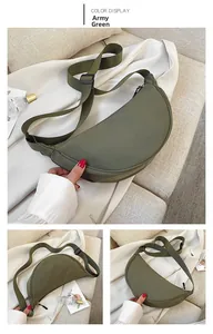 Close-up of army green nylon crescent bag with adjustable strap and zip detail