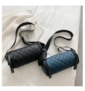 Close-up of quilted cylinder bags showing satin finish and wide fabric straps