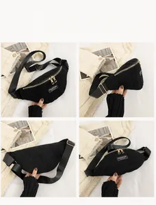Detail view of black corduroy chest bag with gold zippers and fashion instinct label