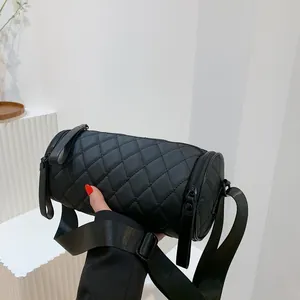 Quilted cylindrical crossbody bag in black nylon with wide adjustable shoulder strap