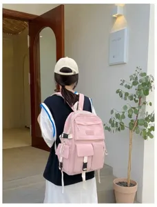 Pink multi-pocket nylon backpack for students featuring adjustable buckles and stylish straps