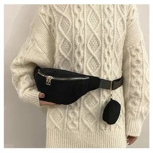 Detail of black corduroy crossbody bag with dual zippers and matching round coin purse
