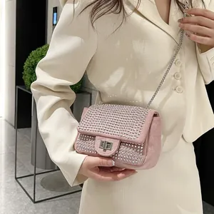 Pink rhinestone square crossbody bag with silver chain strap and metallic twist lock