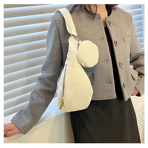 Detail of cream corduroy crossbody bag with round coin purse and adjustable strap