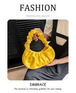 Detailed view of yellow ruched dumpling bag with premium PU leather texture and soft folds
