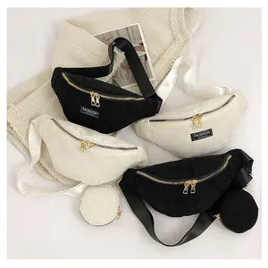 Flat lay of corduroy cross-body bags in black and beige with matching mini coin pouches
