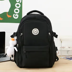 Black high-capacity nylon backpack with cute smile patch and white duck pendant detail