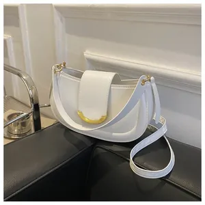 Detail view of white semi-circle shoulder bag with elegant gold U-shaped metal buckle